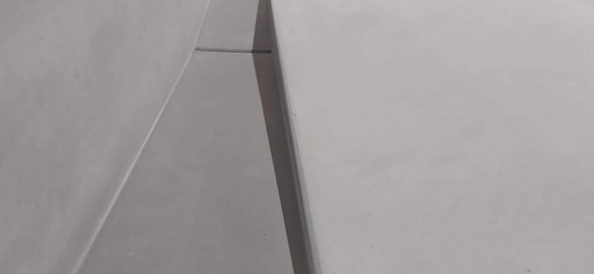 Close-up view of a sloped concrete sink drain
