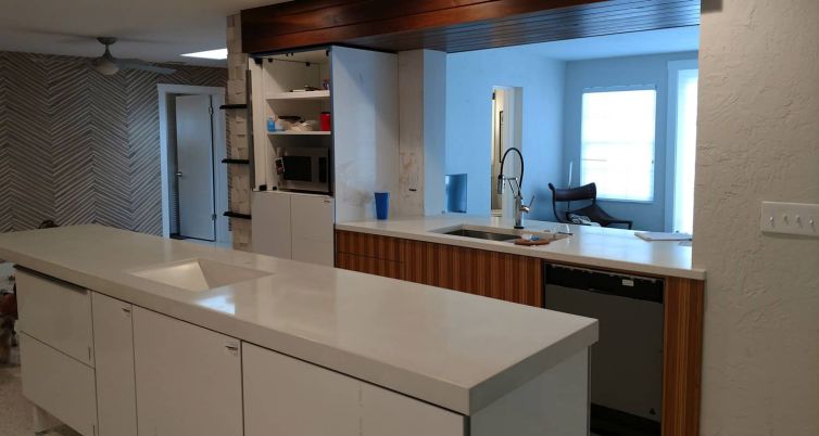 Mid Century Style with White Concrete Countertops and Walnut Cabinetry and Accents
